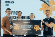 Pixelated photo of a four-person team holding a second place award cheque at a hackathon